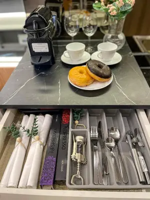 a drawer with two donuts and plates and silverware at Family suite by SMDC fame residence 5 mins to Shaw mrt,megamall,ortigas in Manila