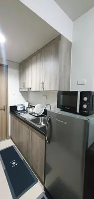 a kitchen with a stainless steel refrigerator and a microwave at C Place - Capsule B - Upper in Manila
