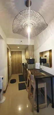 a kitchen with a table and chairs under a ceiling at C Place - Capsule B - Upper in Manila