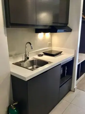 a kitchen with a sink and a counter top at Cozy 1 Studio Room - The Residences BGC Taguig in Manila