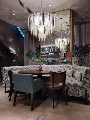 a dining room with a table and a couch at Cozy 1 Studio Room - The Residences BGC Taguig in Manila