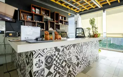 a kitchen with a counter with a laptop on it at Cozy 1 Studio Room - The Residences BGC Taguig in Manila