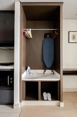 a book shelf in a bedroom with a tv at Cozy 1 Studio Room - The Residences BGC Taguig in Manila