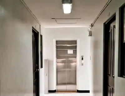 a hallway with a silver elevator in a building at Elegant 2BR Condo unit with free WiFi in Anabu Primero