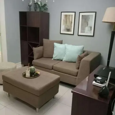 a living room with a couch and a coffee table at Elegant 2BR Condo unit with free WiFi in Anabu Primero