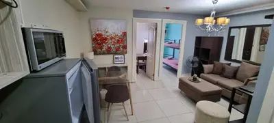 a living room with a television and a living room with a couch at Elegant 2BR Condo unit with free WiFi in Anabu Primero
