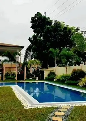 a swimming pool in the yard of a house at Elegant 2BR Condo unit with free WiFi in Anabu Primero