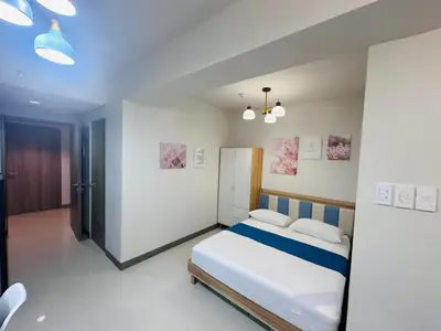 a bedroom with a bed in a room at Serendipity Suite at S Residences in Manila
