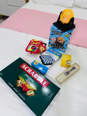 a table with a box of snacks and a magazine at Serendipity Suite at S Residences in Manila