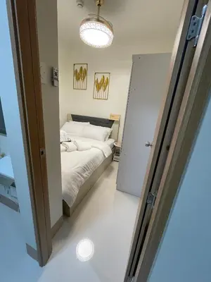 a bedroom with a bed and a sliding door at Molly Shore Getaway Unit 1277 in Manila