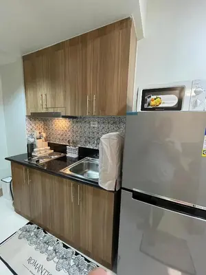 a kitchen with a sink and a refrigerator at Molly Shore Getaway Unit 1277 in Manila