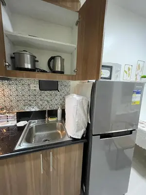 a kitchen with a sink and a refrigerator at Molly Shore Getaway Unit 1277 in Manila