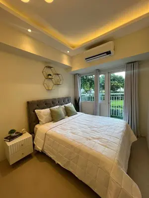 a bedroom with a large white bed and a window at Luxury lodgings by PN Leonardo in Manila
