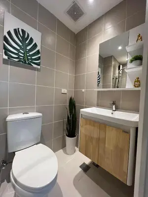 a bathroom with a toilet and a sink at Luxury lodgings by PN Leonardo in Manila
