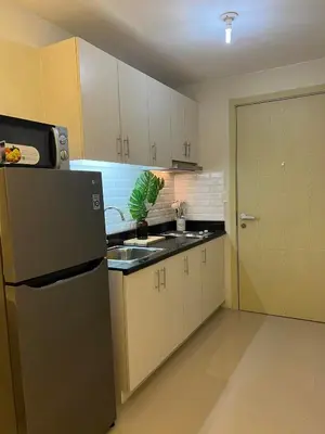 a kitchen with a refrigerator and a sink at Luxury lodgings by PN Leonardo in Manila