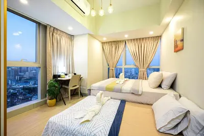 a hotel room with two beds and a window at Premium 3BR Suite UptownBGC w/ Bathtub & Balcony in Manila