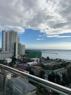 a view of a city with a river and buildings at HOYA Aparthotel In Malate in Manila