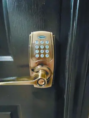 a doorhandle with a cell phone on a door at HOYA Aparthotel In Malate in Manila