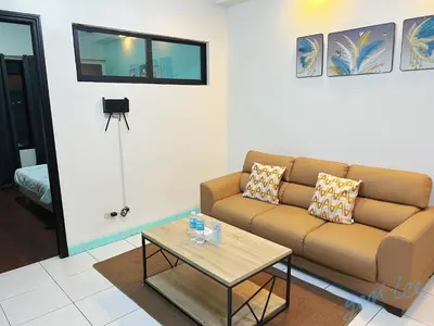 a living room with a couch and a coffee table at HOYA Aparthotel In Malate in Manila