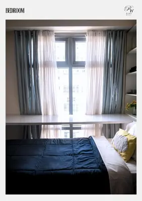 a bedroom with a bed and a window with curtains at Condo in BGC near Grand Hyatt Hotel in Manila