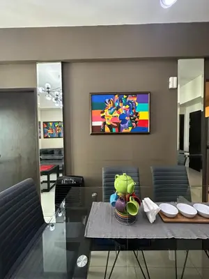 a dining room with a table and a painting on the wall at Condo in BGC near Grand Hyatt Hotel in Manila