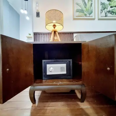 a table with a tv and a lamp on it at 2A2J Apartments - 2 Bedroom in Manila