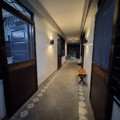 an empty hallway with a door and a bench on the floor at 2A2J Apartments - 2 Bedroom in Manila