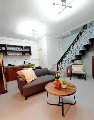 a living room with a couch and a table at 2A2J Apartments - 2 Bedroom in Manila