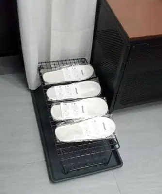 a bunch of white towels in a black basket at 2A2J Apartments - 2 Bedroom in Manila