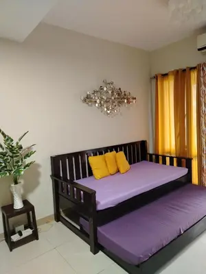 a bed with purple and yellow pillows in a room at 5 Years Legit Staycation Infront of Moa, 2 Bedroom with Balcony at Sea Residences Tower A, Near Arena , Smx, Picc, Dfa Macapagal, World Trade, Star City, Ayala Mall, & Naia Sea Residences Tower A in Manila