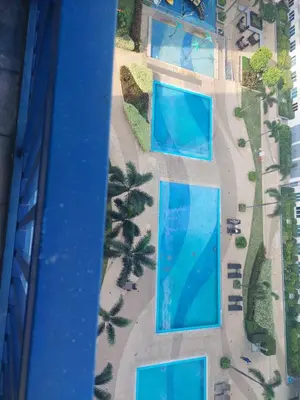an overhead view of three swimming pools on a beach at 5 Years Legit Staycation Infront of Moa, 2 Bedroom with Balcony at Sea Residences Tower A, Near Arena , Smx, Picc, Dfa Macapagal, World Trade, Star City, Ayala Mall, & Naia Sea Residences Tower A in Manila