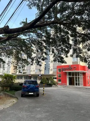 a car parked in a parking lot in front of a building at Affordable Condo Near Nuvali in Silang