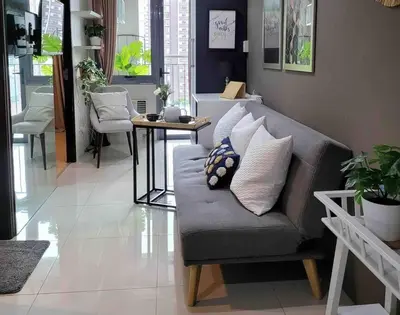 a living room with a couch and a table at Condo in BGC near Grand Hyatt in Manila