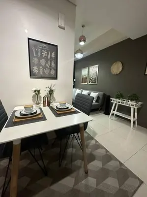 a living room with a table and a couch at Condo in BGC near Grand Hyatt in Manila