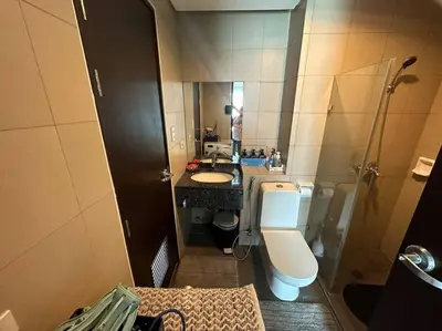 a small bathroom with a toilet and a sink at Condo in BGC near Grand Hyatt in Manila