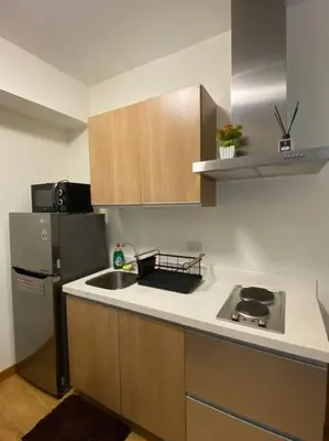 a kitchen with a sink and a refrigerator at Positano 1br Beach View in Manila