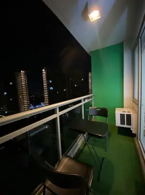 a room with two chairs and a table and a green wall at Positano 1br Beach View in Manila