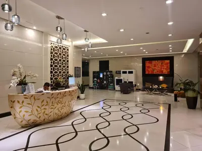 a lobby with a person sitting at a reception desk at Cute Studio Unit w/ Big Windows - B Morgan T1 in Manila