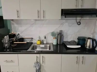 a kitchen with a sink and a counter top at Cute Studio Unit w/ Big Windows - B Morgan T1 in Manila