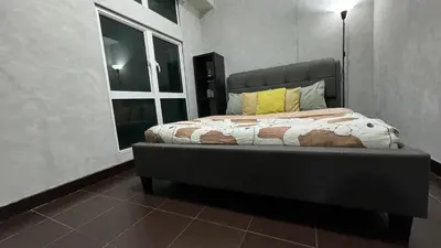 a bed in a room with a large window at Toby’s Crib at San Lorenzo Place in Manila