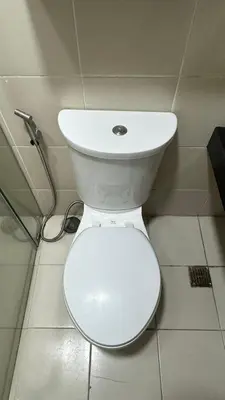 a bathroom with a white toilet in a room at Toby’s Crib at San Lorenzo Place in Manila