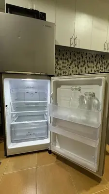 an open refrigerator with two glass jars in it at Toby’s Crib at San Lorenzo Place in Manila