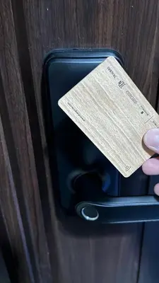 a person holding a tag on a suitcase at Toby’s Crib at San Lorenzo Place in Manila