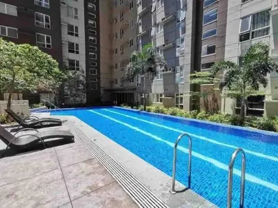 a swimming pool in front of a building at Condo in Metro Manila V PAD in Manila