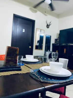 a table with plates and cups and a cake on it at Condo in Metro Manila V PAD in Manila