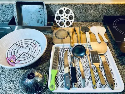 a kitchen counter with a tray of kitchen utensils at Condo in Metro Manila V PAD in Manila