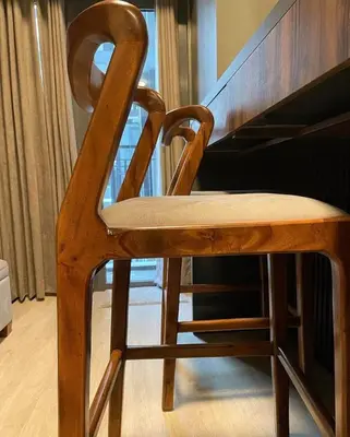 a wooden chair sitting next to a piano at SATELUXXE CAVE SHORE 3 in Manila