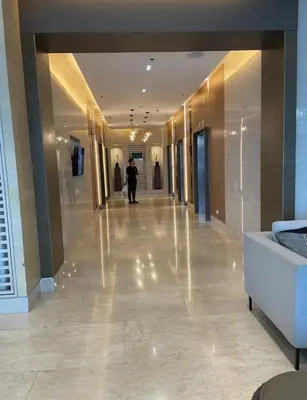 a hallway in a building with a person walking down it at SATELUXXE CAVE SHORE 3 in Manila