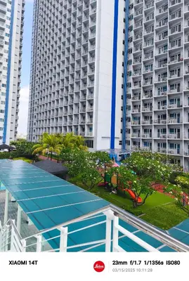 an overhead view of a tennis court in front of tall buildings at Condo unit in Manila