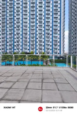 a large building with tall buildings in the background at Condo unit in Manila